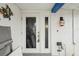 Front entrance with a door that has glass panes and a unique light fixture at 928 Spindle Palm Way, Apollo Beach, FL 33572