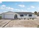A one-story white stucco home with an attached garage, offering a blank canvas for lush landscaping at 928 Spindle Palm Way, Apollo Beach, FL 33572