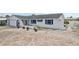 A white one-story home with blue trim and an attached garage, ripe for customization with landscaping at 928 Spindle Palm Way, Apollo Beach, FL 33572