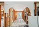 Hallway featuring wood framework and an archway, offering a view of an exterior door and renovation opportunities at 928 Spindle Palm Way, Apollo Beach, FL 33572