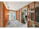 Bright hallway with exposed wood framework, leading to a glass door and featuring potential for customization at 928 Spindle Palm Way, Apollo Beach, FL 33572