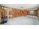 Unfinished interior with wooden frames, cinder block walls, and concrete flooring at 928 Spindle Palm Way, Apollo Beach, FL 33572