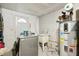 Laundry room with a washer, dryer, utility sink, and water heater for convenience at 928 Spindle Palm Way, Apollo Beach, FL 33572