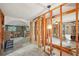 Spacious room featuring exposed wood framework, unfinished floors, and vintage light fixtures, ready for renovation at 928 Spindle Palm Way, Apollo Beach, FL 33572