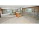 Large room featuring exposed wood framework, concrete block walls, and windows, offering ample renovation potential at 928 Spindle Palm Way, Apollo Beach, FL 33572