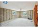 Large living space with cinder block walls, wood framing, windows, and a ceiling fan at 928 Spindle Palm Way, Apollo Beach, FL 33572