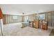 Spacious living room featuring an open layout, ample natural light from windows, and slider doors at 928 Spindle Palm Way, Apollo Beach, FL 33572