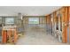 Unfinished space with exposed framework, concrete block walls, and a stainless steel range hood, ready for remodeling at 928 Spindle Palm Way, Apollo Beach, FL 33572