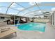 Spacious screened-in pool with a large deck for entertaining and relaxing in the sun or shade at 928 Spindle Palm Way, Apollo Beach, FL 33572