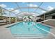 Beautiful screened-in pool with clear blue water, perfect for swimming and enjoying the outdoors at 928 Spindle Palm Way, Apollo Beach, FL 33572