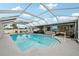 Inviting screened-in pool area with plenty of space for lounging and entertaining by the sparkling pool at 928 Spindle Palm Way, Apollo Beach, FL 33572