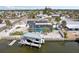 Waterfront home featuring a boat lift, screened pool, solar panels, and fenced yard at 928 Spindle Palm Way, Apollo Beach, FL 33572