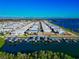 Stunning aerial view showcasing waterfront homes with boat docks along tranquil blue waters at 10315 Cortez W Rd # 38Bv, Bradenton, FL 34210