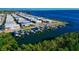 Beautiful aerial perspective of waterfront properties featuring boat docks and a serene blue bay at 10315 Cortez W Rd # 38Bv, Bradenton, FL 34210