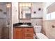 Bathroom featuring granite countertop, wooden vanity, glass enclosed shower, and modern toilet at 10315 Cortez W Rd # 38Bv, Bradenton, FL 34210