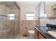 Bathroom showcasing a glass door shower, a modern vanity, and tiled walls at 10315 Cortez W Rd # 38Bv, Bradenton, FL 34210
