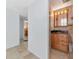 Hallway view of bathroom with shower and vanity with dark countertop at 10315 Cortez W Rd # 38Bv, Bradenton, FL 34210