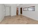 Neutral bedroom featuring tile flooring, wood-look blinds, and an adjacent bathroom at 10315 Cortez W Rd # 38Bv, Bradenton, FL 34210