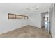 Bedroom with a ceiling fan, light walls, window with wood blinds and tiled floors at 10315 Cortez W Rd # 38Bv, Bradenton, FL 34210