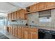Kitchen features oak cabinetry, tile backsplash, and stainless steel appliances for a modern cooking experience at 10315 Cortez W Rd # 38Bv, Bradenton, FL 34210