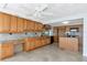 Spacious kitchen with oak cabinets, tiled floor, central island and stainless steel appliances at 10315 Cortez W Rd # 38Bv, Bradenton, FL 34210