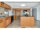 Open concept kitchen with oak cabinetry, granite countertops, and a central island at 10315 Cortez W Rd # 38Bv, Bradenton, FL 34210