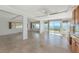 Bright living room with tile flooring, ceiling fan, and sliding glass doors to balcony with water view at 10315 Cortez W Rd # 38Bv, Bradenton, FL 34210