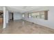 Open-concept living room features tile floors, multiple windows, and ceiling fan at 10315 Cortez W Rd # 38Bv, Bradenton, FL 34210