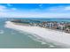 An aerial view of a coastline with tall buildings, beaches, ocean waves, and a few scattered clouds on a sunny day at 106 N Blvd Of The Presidents, Sarasota, FL 34236