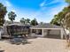 Aerial view shows the carport next to an enclosed pool with tropical surroundings at 106 N Blvd Of The Presidents, Sarasota, FL 34236