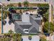 Aerial view of property and neighborhood with mature trees and tropical landscaping at 106 N Blvd Of The Presidents, Sarasota, FL 34236