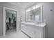Bright bathroom with double vanity and walk-in closet access for ample storage at 106 N Blvd Of The Presidents, Sarasota, FL 34236
