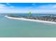 Expansive beach with turquoise waters under a clear blue sky offering a picturesque coastal view with an aerial perspective at 106 N Blvd Of The Presidents, Sarasota, FL 34236