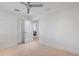 Bright bedroom featuring a ceiling fan, walk in closet, and neutral color palette at 106 N Blvd Of The Presidents, Sarasota, FL 34236