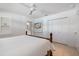 Bright bedroom featuring a ceiling fan, television, and closet with paneled doors at 106 N Blvd Of The Presidents, Sarasota, FL 34236