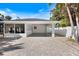 Exterior view of the modern carport with an attached garage and a brick-paved driveway at 106 N Blvd Of The Presidents, Sarasota, FL 34236