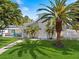 Charming home with a lush green lawn, mature trees and attractive landscaping, a welcoming sight for all at 106 N Blvd Of The Presidents, Sarasota, FL 34236