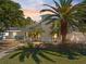 Stunning exterior view of a modern home with lush tropical landscaping and a beautiful walkway at 106 N Blvd Of The Presidents, Sarasota, FL 34236