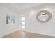A foyer with bright white walls, tile flooring, a round mirror, and recessed lighting at 106 N Blvd Of The Presidents, Sarasota, FL 34236