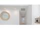 Hallway leading to the living area, adorned with a decorative mirror and recessed lighting at 106 N Blvd Of The Presidents, Sarasota, FL 34236