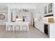 Well-appointed kitchen with white cabinets, modern appliances, a center island, and stylish lighting at 106 N Blvd Of The Presidents, Sarasota, FL 34236