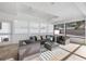 Outdoor lanai with comfortable seating, ceiling fans, and views of the backyard at 106 N Blvd Of The Presidents, Sarasota, FL 34236