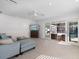 Cozy living room with views of the pool, comfortable seating, and a wall-mounted TV at 106 N Blvd Of The Presidents, Sarasota, FL 34236