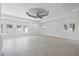 Well-lit living room showcases tile floors, a statement ceiling fan, and bright windows enhancing the appeal at 106 N Blvd Of The Presidents, Sarasota, FL 34236
