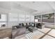 Well-lit living area featuring modern furnishings, a ceiling fan, and multiple windows with serene views at 106 N Blvd Of The Presidents, Sarasota, FL 34236