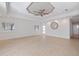 Spacious living room featuring a decorative ceiling, tile floors, and ample natural light at 106 N Blvd Of The Presidents, Sarasota, FL 34236