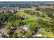 Aerial view of property nestled among mature trees, adjacent to green space and near the coast at 109 Burney Rd, Osprey, FL 34229