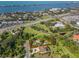 Aerial view of property with a waterfront location, mature trees, and proximity to the coast and highway at 109 Burney Rd, Osprey, FL 34229