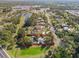 Aerial view of property with a defined boundary, showcasing the house, mature trees, and surrounding landscape at 109 Burney Rd, Osprey, FL 34229