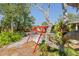 Cozy backyard with a red swing set at 109 Burney Rd, Osprey, FL 34229